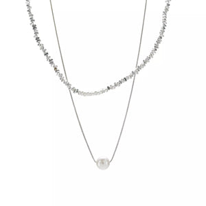 Elegant double layered silver necklace with pearl accent and textured beads