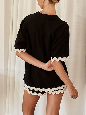 Black lounge set with scalloped trim on short sleeves and shorts
