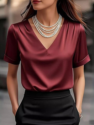 Wine red satin v-neck shirt with cuffed sleeves and layered necklace