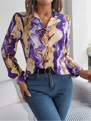 Women's abstract swirl print silk blouse with button front and long sleeves.