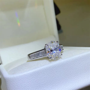Silver oval cut diamond ring with baguette accents on band
