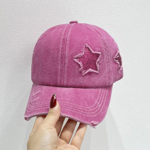 Hot pink baseball cap with glitter star patches and distressed details.