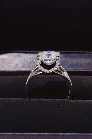 Sterling silver solitaire ring with a diamond halo and brilliant center stone.