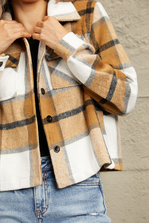 Camel plaid shacket with contrast collar, buttoned front, and chest pockets.