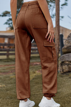 Brown cargo pants with elastic cuffs and multiple pockets.