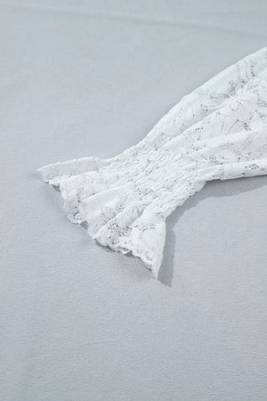 White lace blouse with smocked sleeve and ruffled cuff detail