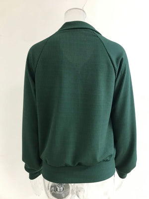 Green ribbed knit plus size trench coat with collar and elastic cuffs.