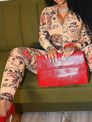 Tattoo print zip front jumpsuit with long sleeves and form-fitting cut.