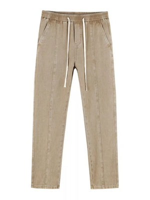 Tan relaxed fit cotton jeans with drawstring waist and front seams.