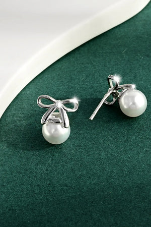 Silver bow pearl drop earrings with a polished finish.
