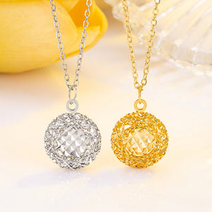 Elegant plated sterling pendant necklace in gold and silver with intricate cage design.