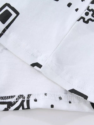 White cotton kids' t-shirt with black geometric construction vehicle print and stitched hem.
