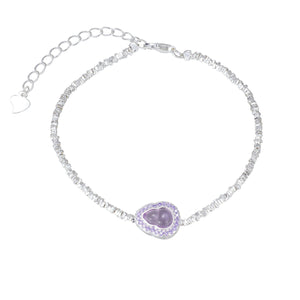Silver beaded bracelet with a purple gourd-shaped charm and crystal accents.