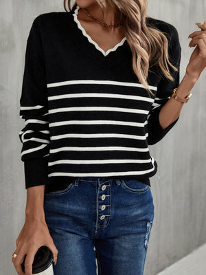 Black and white striped knit sweater with scalloped trim V-neck and long sleeves.
