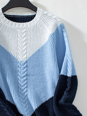 Chevron cable knit sweater in pastel blue and white colorblock with cable knit details.