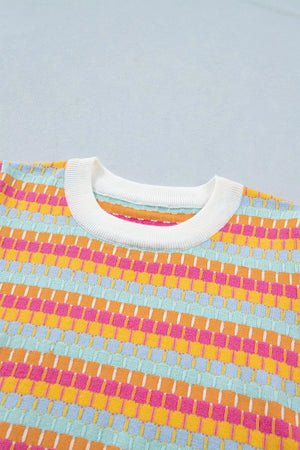 Vibrant abstract knit sweater with crew neck and ribbed trim in colorful stripes.