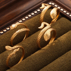 Gold textured snake wrap rings, Style A, B, and C, detailed scales and heads.