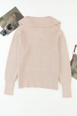 Beige ribbed knit cardigan with shawl collar and long sleeves.