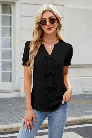 Black textured blouse with V-neck and three bow-tie details