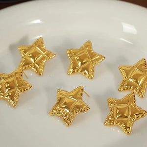 Gold textured celestial star stud earrings with diamond pattern detail.