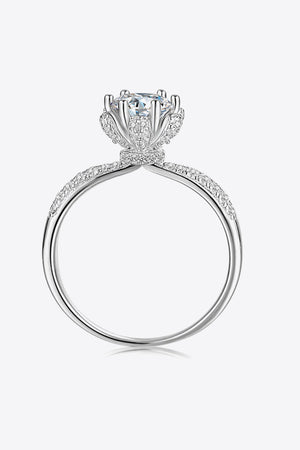 Silver halo moissanite ring with pavé band and floral-inspired setting.