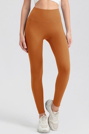 Caramel high-waist performance leggings with sculpting seams.