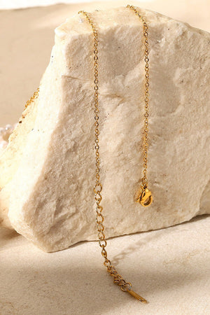 Gold-plated chain necklace with adjustable clasp and extender detail.