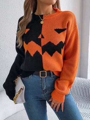 Split-face pumpkin knit sweater in orange and black acrylic with crewneck and long sleeves.