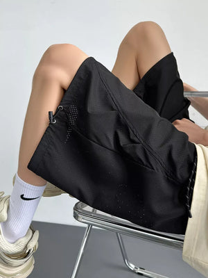 Black chino shorts with drawstring and perforated detail.