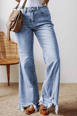 Medium wash denim flare jeans with raw hem detail.