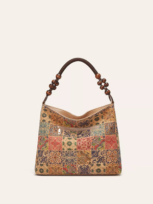 Vibrant bohemian hobo tote with geometric tile pattern and beaded strap.