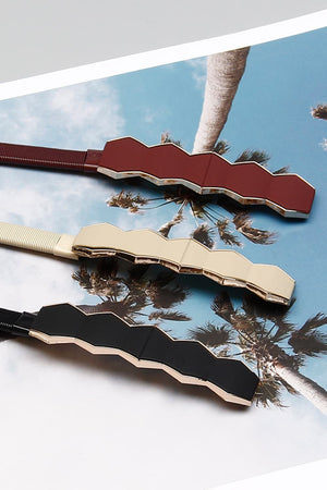 Geometric buckle waist belts in black, cream, and wine with elastic bands.