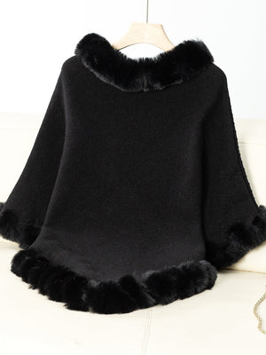 Black knit poncho with faux fur trim on neckline and hem