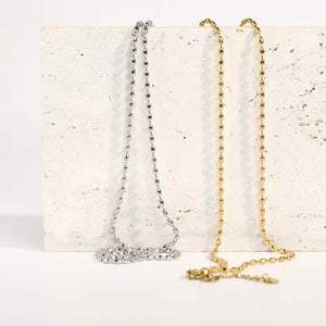 Dual-tone capsule chain necklace in gold and silver with oval bead links.