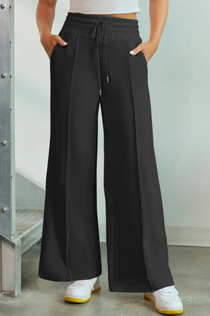 Black palazzo joggers with center seam detail and drawstring waist.