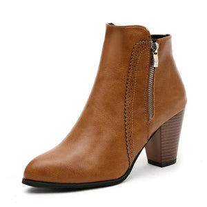 Caramel laser-cut detail block heel booties with side zipper and pointed toe.
