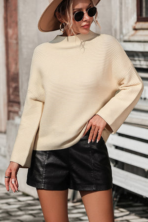 Ribbed mock neck sweater in tan with volume sleeves and a relaxed fit.