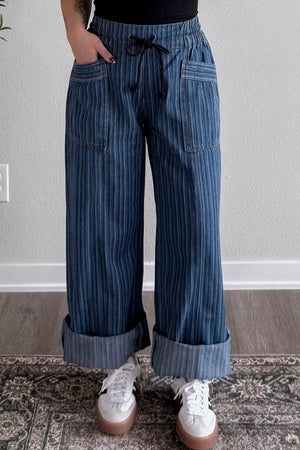 Maternity wide-leg jeans with drawstring waist, vertical pinstripe pattern, and cuffed hems.