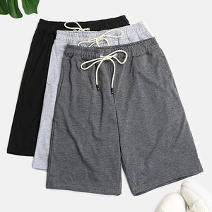 Relaxed culotte lounge shorts in black, light gray, and dark gray with drawstring waists.