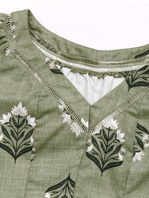 Botanical print V-neck blouse in matcha green with decorative trim and a textured fabric.