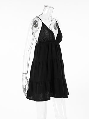 Black cotton tiered mini dress with lace trim and spaghetti straps