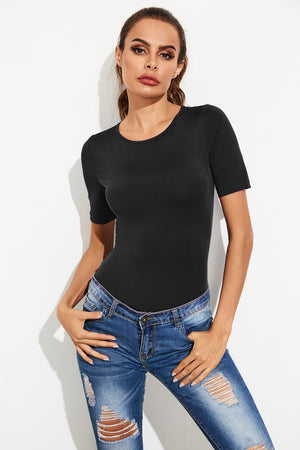 Black crew-neck jersey bodysuit with short sleeves, styled with ripped jeans.