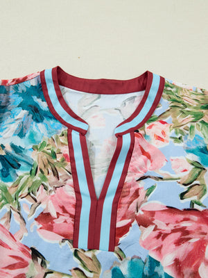 Women's cotton V-neck blouse with a floral print and striped trim detail.