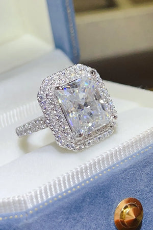Radiant cut moissanite halo ring in silver with a double halo of sparkling stones.