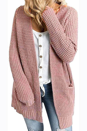 Dusty pink waffle knit longline cardigan with pockets and open front, worn over a white button-up shirt.