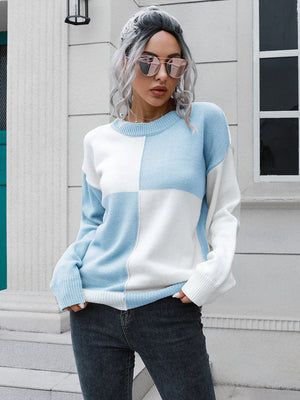 Colorblock knit sweater in pastel blue and white acrylic with crew neck and long sleeves.