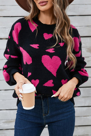 Black intarsia knit jumper with pink hearts, crew neck, long sleeves, acrylic blend.