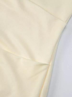 Yellow ruched maxi dress detail showing fabric texture and seam.