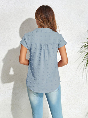 Light blue textured dot poplin shirt with short sleeves and a collared neckline.