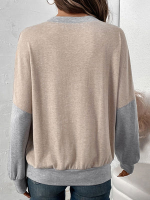 Layered V-neck sweatshirt in tan and gray colorblock with crew neck and long sleeves.